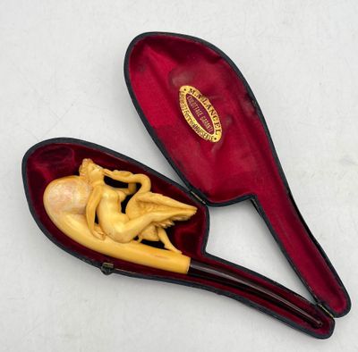 a small wooden spoon with a figurine inside of it