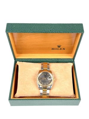 an image of a rolex watch in a box on a white background
