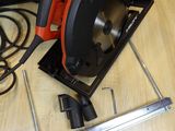 a circular saw on a table next to other tools