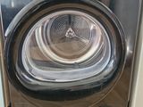 une machine à laver et un sèche-linge posés sur un parquet