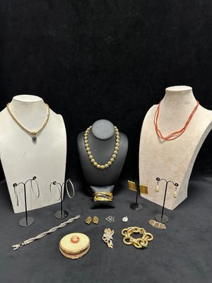several different types of jewelry displayed on display on a black background