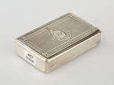 an antique silver cigarette case with a lion emblem on the front