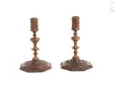 pair of antique brass candlesticks on a white background
