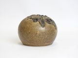 a small brown vase with a leaf design on it
