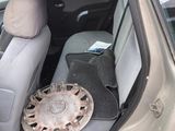 an image of a dirty car with a wheel in the back seat