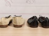 three pairs of shoes are lined up on a wooden table