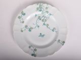a white plate with blue flowers and a bird on it