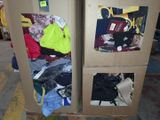 two cardboard boxes that have clothes in them on a carton