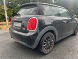 a small black car parked on the side of the road
