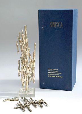 an image of a silver sculpture next to a blue box