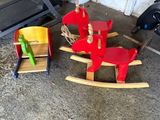 two wooden rocking horses sitting next to each other on the floor