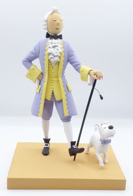 figurine représentant un homme avec une canne et un chien, posée sur un socle