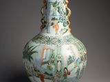 a vase that is sitting on a table with a lamp on it
