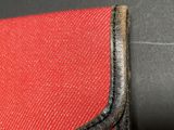 red and black leather wallet with black stitching on the inside