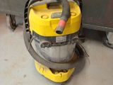 a yellow and black vacuum on the floor in a room