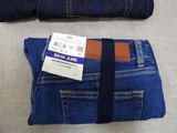 two pairs of blue jeans and a brown belt
