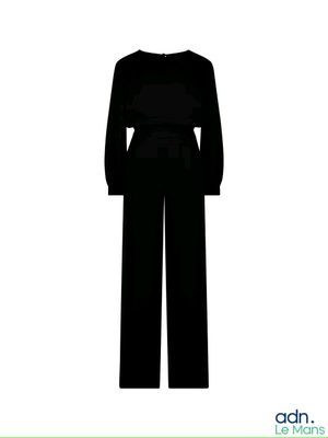 the silhouette of a woman in a black jumpsuit is shown