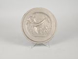 an image of a silver plate with a woman and a bird on it
