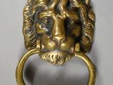 an image of a lion head door knocket on a white background