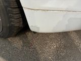 a close up of a car ' s front bumper and tire