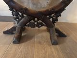 a wooden table with a metal plate on top of it