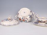 three pieces of porcelain ware are sitting on a white surface