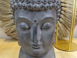 a statue of a person with a head of hair on a table