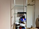 a man standing in a room with a glass shelf