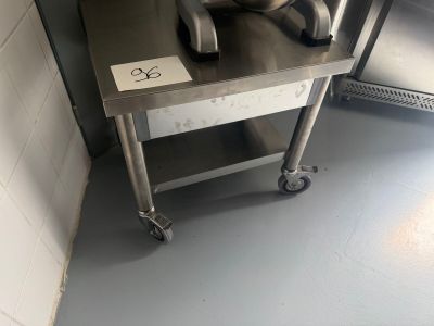 a metal table with a mixer on it in a kitchen