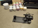 a machine that is sitting on a table with some paint