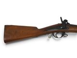 un fusil avec un canon en bois sur fond blanc