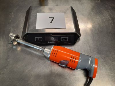 a small electric tool sitting on a table next to a box