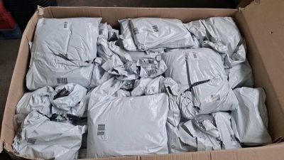 a cardboard box filled with bags of white stuff
