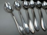 six spoons that are sitting on a table