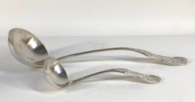 two silver spoons are sitting on top of a white surface