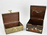 two wooden boxes that have shells in them on them
