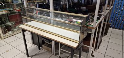 a glass display case in the middle of a store