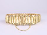 a gold bracelet with a chain and clasp