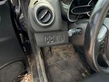 a car dashboard with a steering wheel and dashboard buttons