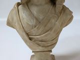 marble bust of a woman with a hat on her head