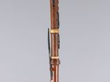 a wooden bassoon with a black and white design on it