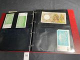 an open red folder with stamps on it on a table