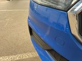 a close up of the front of a blue car