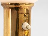 brass plated table lamp with a white glass shade on a white background
