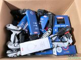 a cardboard box filled with assorted skates and equipment