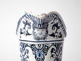 a blue and white vase sitting on top of a table
