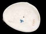 a white porcelain object with a blue and red design on it