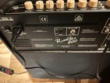 a guitar amp sitting on top of a wooden table