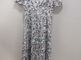 the dress is hanging on a hanger on the wall