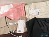 a lot of clothes that are sitting on a table